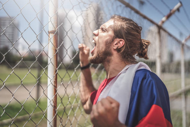 istock Russian fan watching a soccer game 932747402