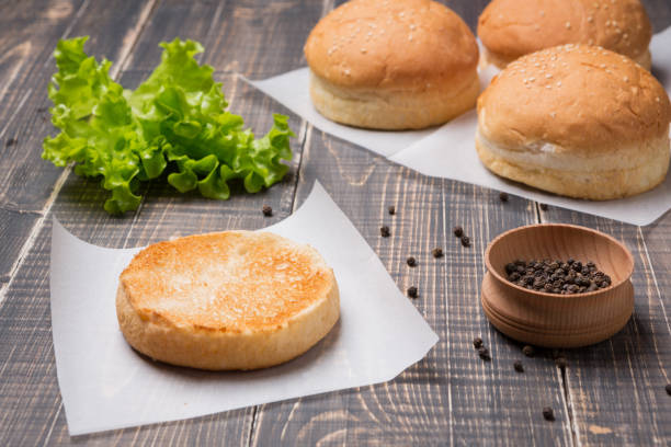 istock burger for a hamburger cut, cooking concept, on a wooden table, lettuce leaves 932747600