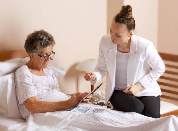 istock Old woman with senior social work assistant. 932747634