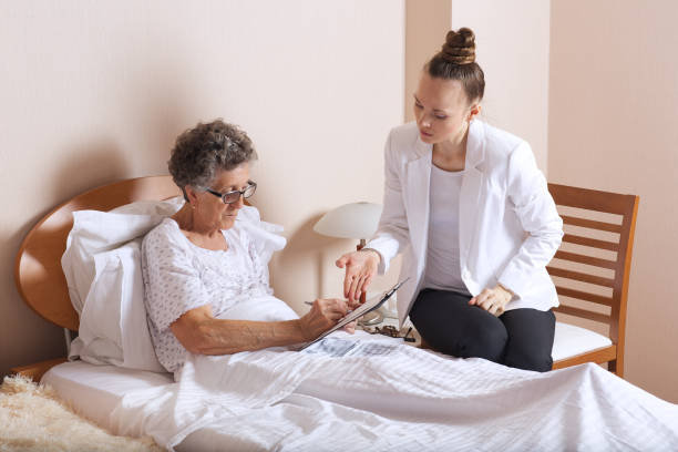 istock Old woman with senior social work assistant. 932747638
