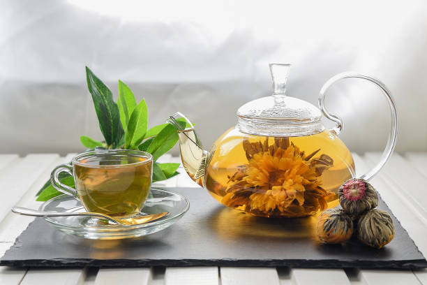 istock Exotic green tea with flowers in glass teapot 932750432