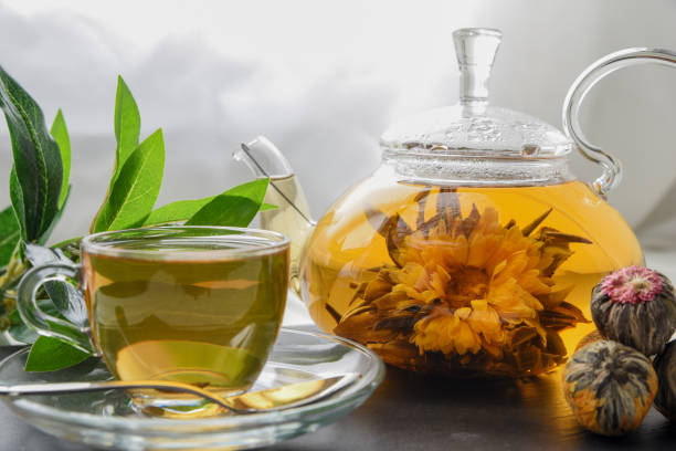 istock Exotic green tea with flowers in glass teapot 932750450