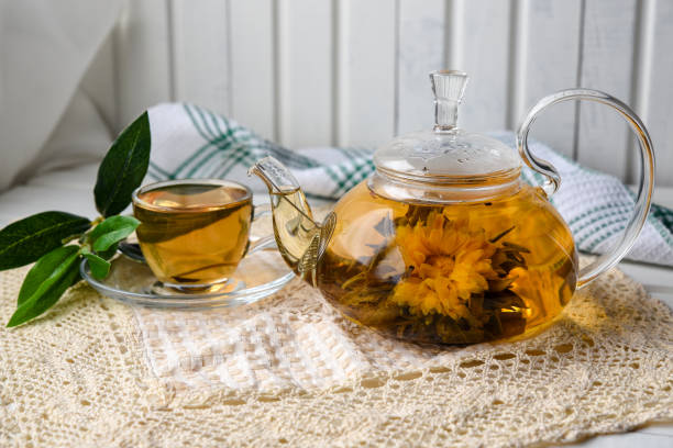 istock Exotic green tea with flowers in glass teapot 932750456