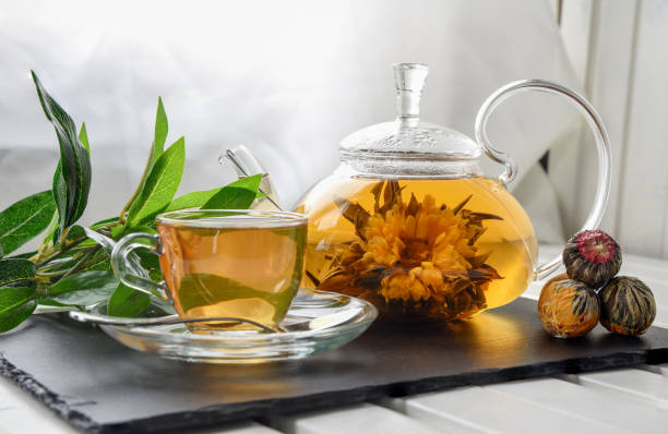 istock Exotic green tea with flowers in glass teapot 932750526