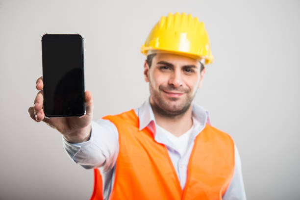istock Selective focus of architect holding black screen smartphone 932750556
