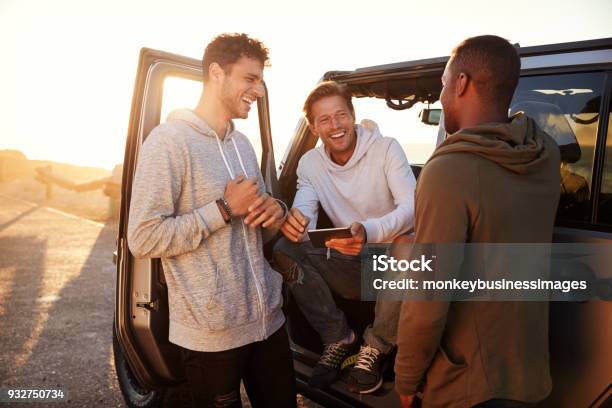 Three Male Friends On A Road Trip Using A Tablet Computer Stock Photo - Download Image Now