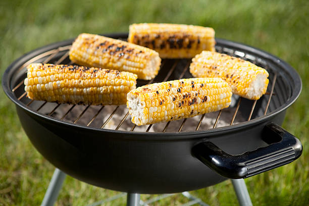 Fresh corn on the cob on a charcoal grill  stock photo