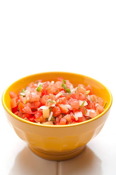 Yellow bowl of salsa on a white background stock photo