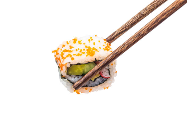 istock Sushi pieces placed between chopsticks, separated on white background. Popular sushi food. 932763170