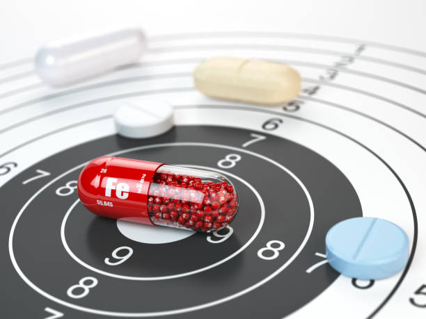istock Pill with iron FE ferrum element in the center of target.Dietary supplements, vitamines and nutritional concept. 932763494