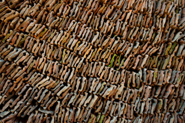 Tile roof slate stacked for use in home construction. Construction asbestos-cement slates. Stack of ceramic pattern background.