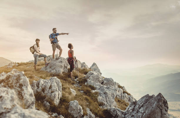 istock Small Group of People Standing on Top of Hill 932768266