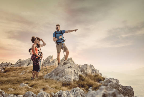 istock Small Group of People Standing on Top of Hill 932768274