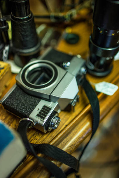 istock Old style retro film camera without a lens sat on a wooden table 932768800