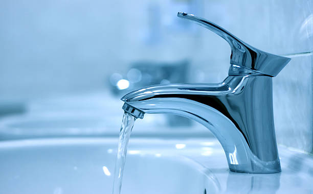 istock Faucet running water in a public restroom 93276928