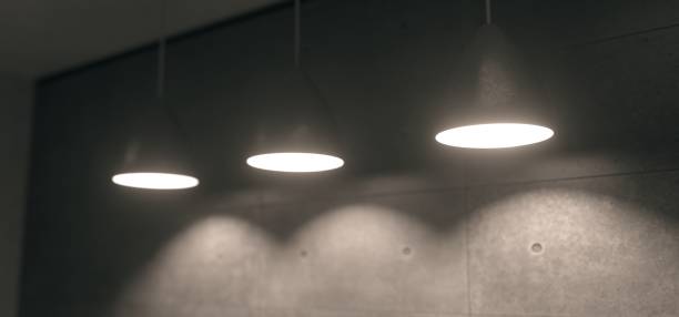 istock Realistic Hanging Lights In Concrete Room With Soft Focus 932774884