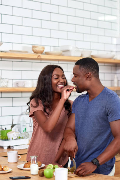 istock Happy couple at home having breakfast together and laughing 932778894