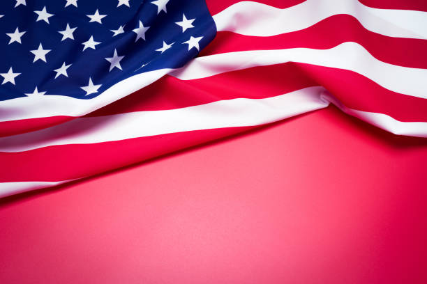 istock Closeup of American flag on red background. 932783380
