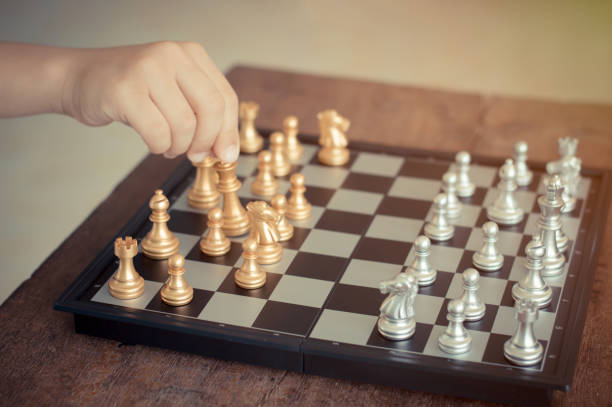 istock Kid hold chess pieces in chess game selective focus vintage style for education or business concept. 932789770
