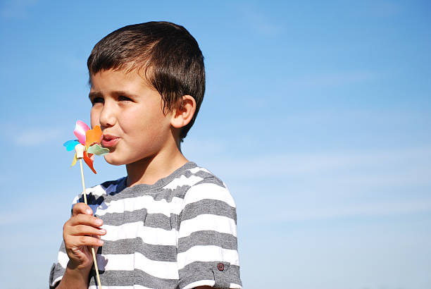 Young boy with toy windmill stock photo
