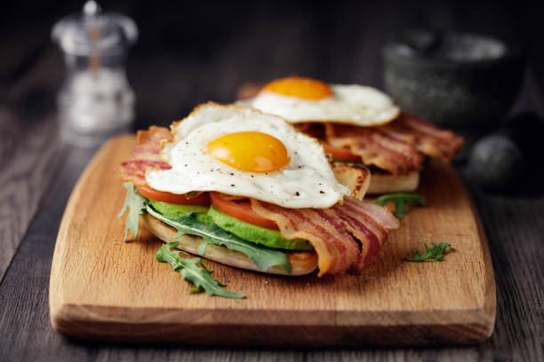 Healthy bacon fried egg brunch Home made freshness bacon,fried egg with avocado ,tomato and rocket leaves on fried soda bread brunch photos stock pictures, royalty-free photos & images