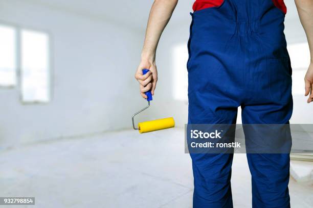 Construction Worker With Paint Roller Ready For Apartment Painting Stock Photo - Download Image Now