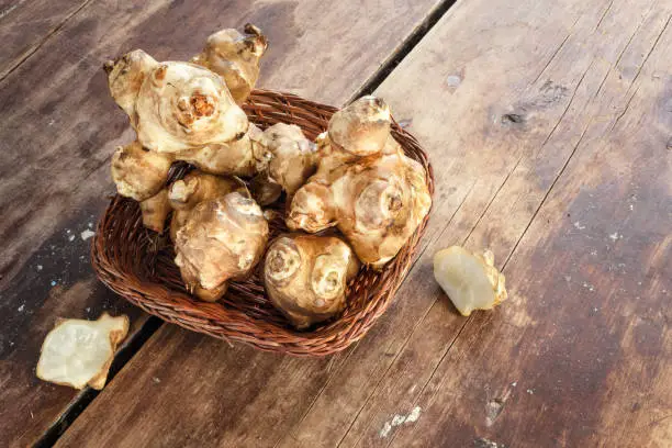 Jerusalem artichoke is fresh, on a wooden background