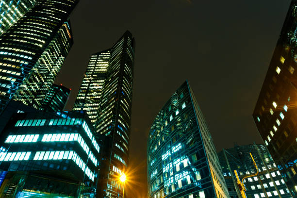 istock Illuminated office buildings in Paris business district. 932799336