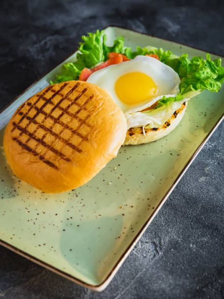 istock Delicious american hamburger with egg, lettuce and salmon red fish 932801664