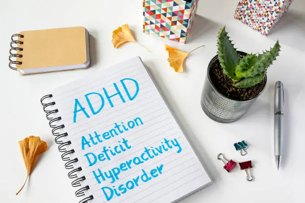 Photo of ADHD Attention Deficit Hyperactivity Disorder written in notebook