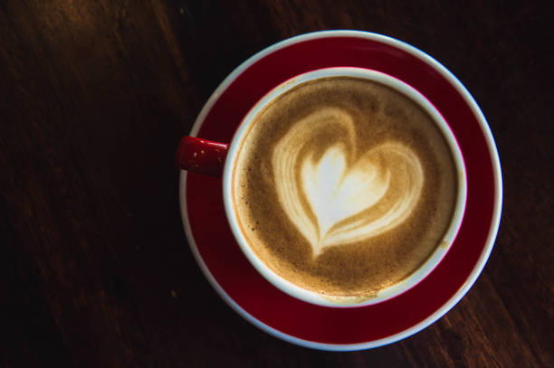 istock the red cup coffee love , coffee dark in wood dark table 932802974