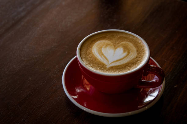 istock the red cup coffee love , coffee dark in wood dark table 932802978