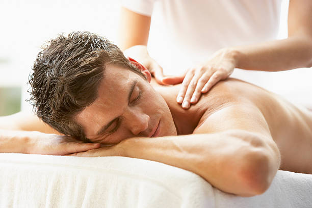 Man Enjoying Massage At Spa Young Man Enjoying Massage At Spa man massage stock pictures, royalty-free photos & images