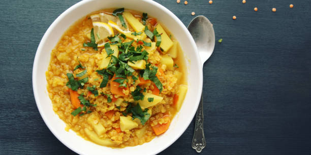 istock Red lentil stew on the round white plate. Top view 932815614