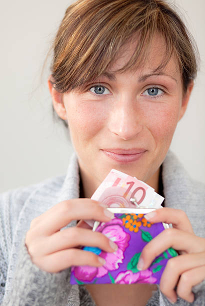 female holding money pocket stock photo