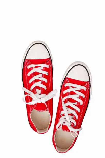 Photo of pair of sneakers-colored youth running shoes on a white background, isolated