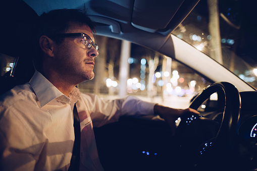 Man driving at night in the city