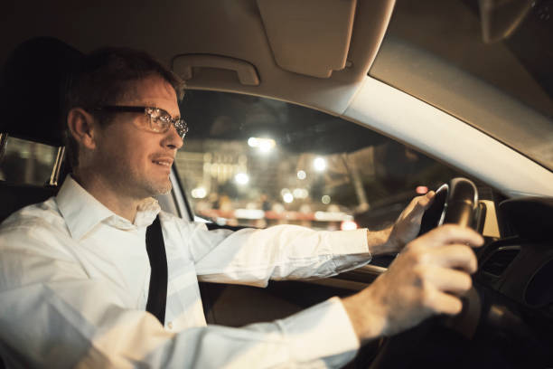 istock Man driving at night in the city 932826288