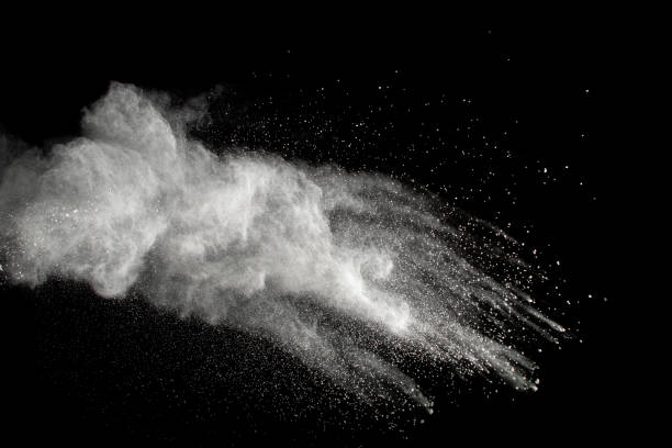 istock Launched white powder splash on black background. Bizarre forms of of white powder explosion cloud against dark background. 932827606