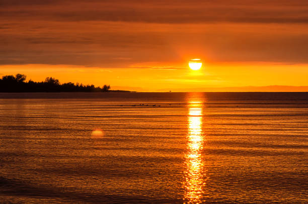istock Beautiful red sunset over the lake with mountain 932829840