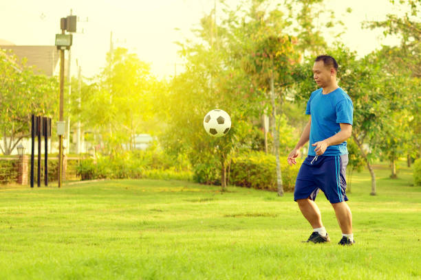 istock Asian man with football 932831790