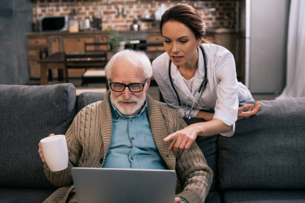 istock Doctor pointing at laptop in senior patient hands 932836746