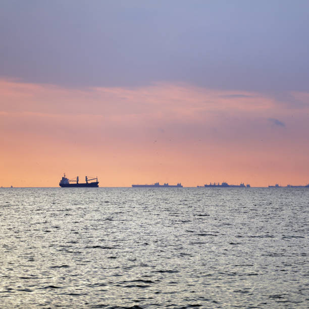 istock Industrial Ship Silhouettes with Sunbeams 932836824