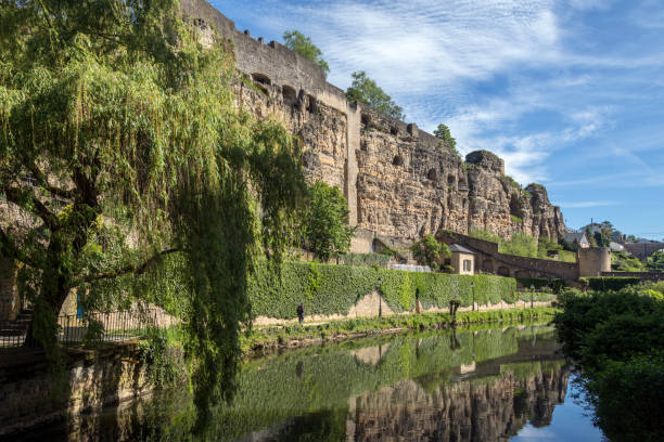 Luxembourg City in the Grand Duchy of Luxembourg Luxembourg City or Ville de Luxembourg in the Grand Duchy of Luxembourg. Part of the walls of the old town viewed from the Grund area of the city. petrusse stock pictures, royalty-free photos & images