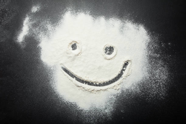 istock Preparation of dough from flour on a black background. 932840632