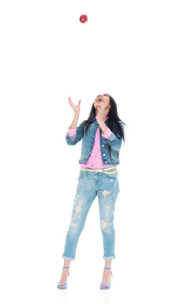 istock Beautiful young latino woman throwing an apple 932840656