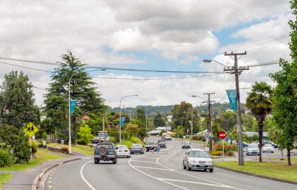 Daytime traffic in New Zealand Whangarei, New Zealand - Cars and trucks on a curving road in the town of Whangarei in the Northland region of New Zealand's North Island. northland new zealand stock pictures, royalty-free photos & images