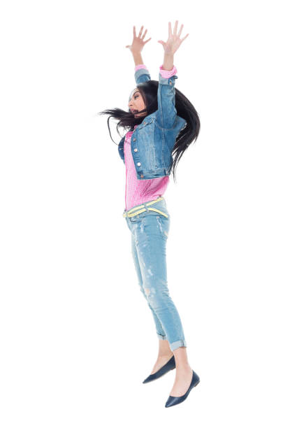 istock Pretty lady in double denim jumping and having fun 932842158
