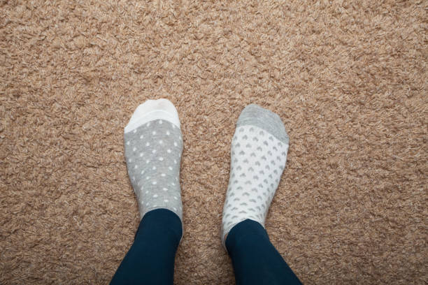 istock The girl is on the floor in socks 932845012