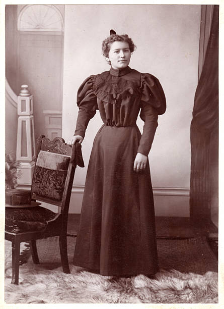 Vintage sepia photo of an elaborately dressed woman.